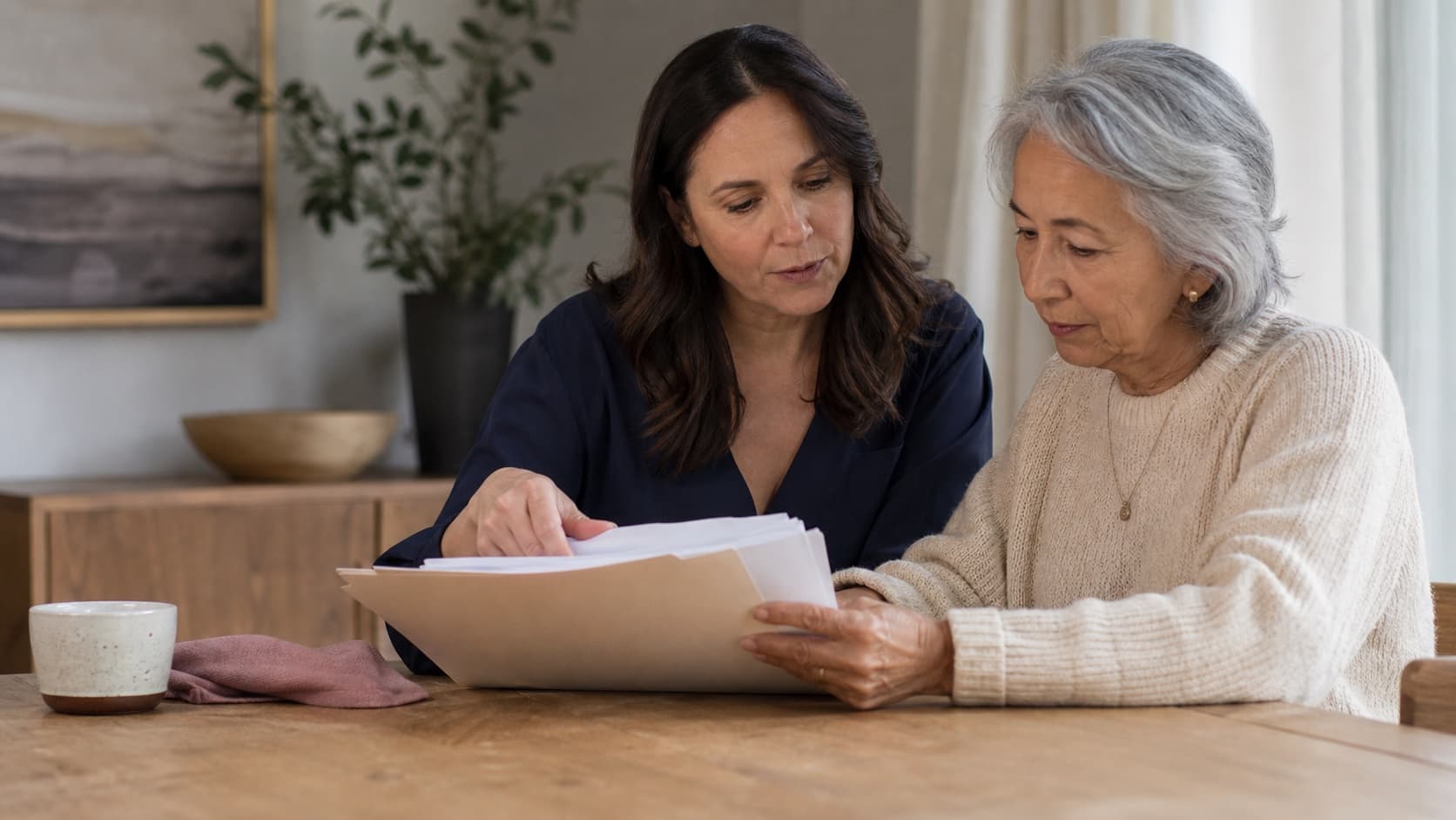 A woman helping an older family member organize records at home