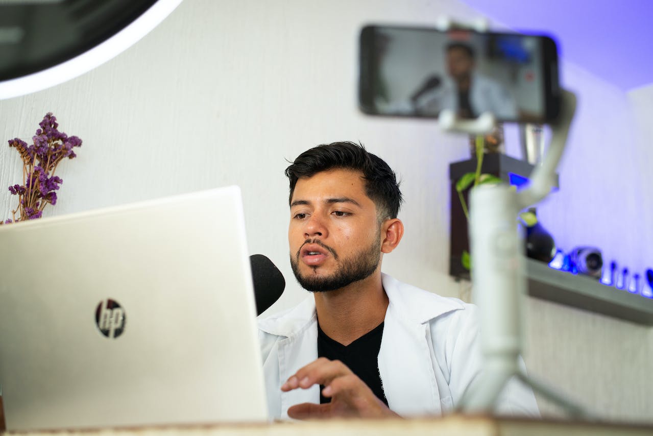 A doctor entering data onto a laptop. 