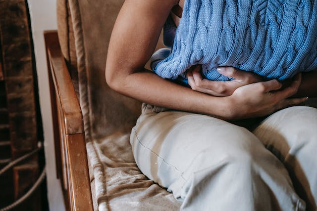A woman experiencing intense stomach pain.