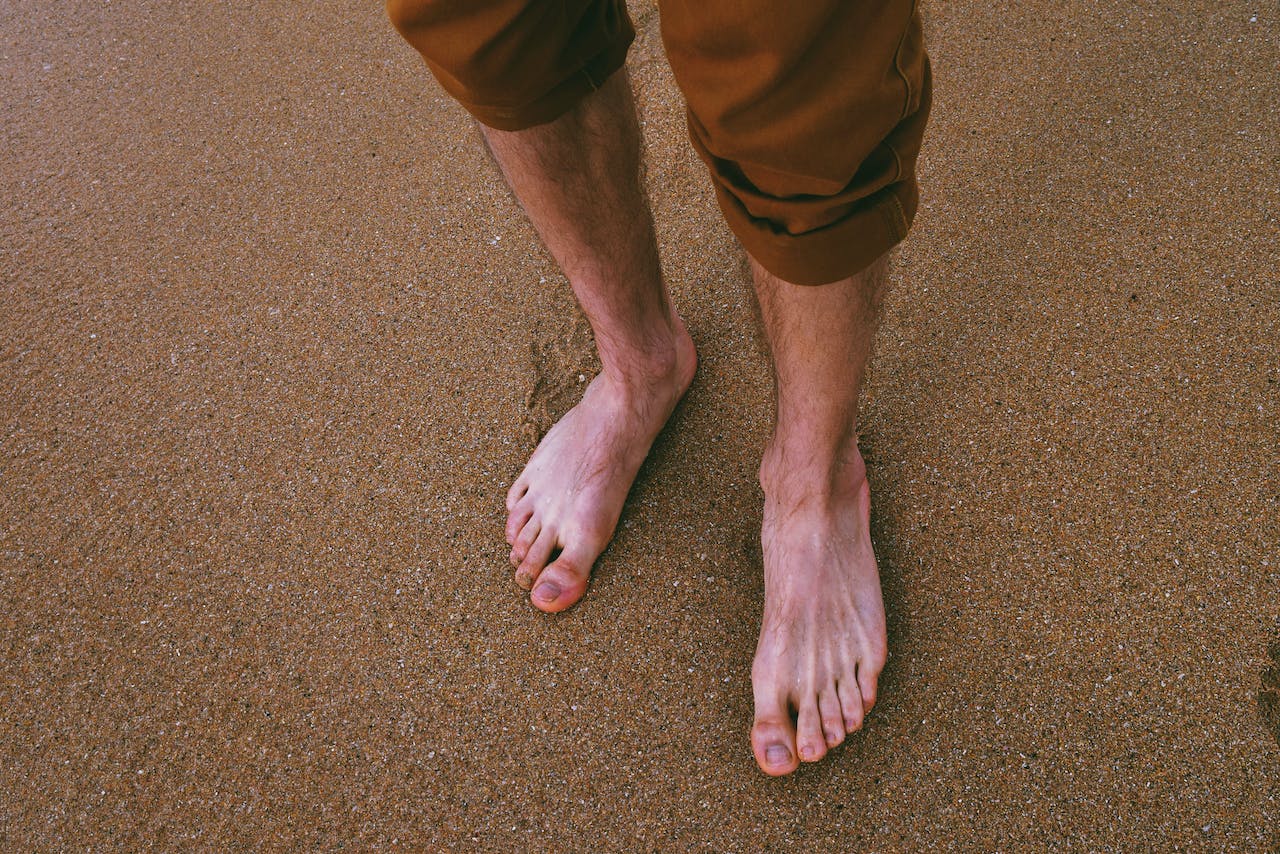 Picture of a man's feet at the beach.