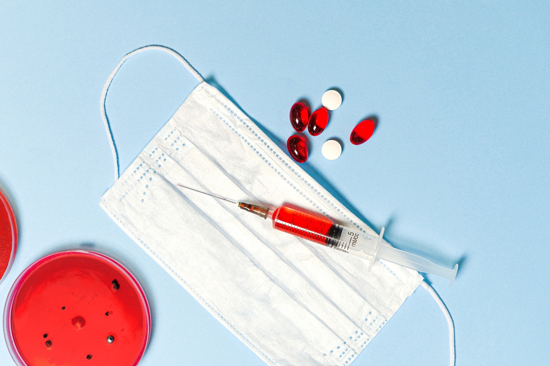 An image of lab testing equipment, syringes, tablets.