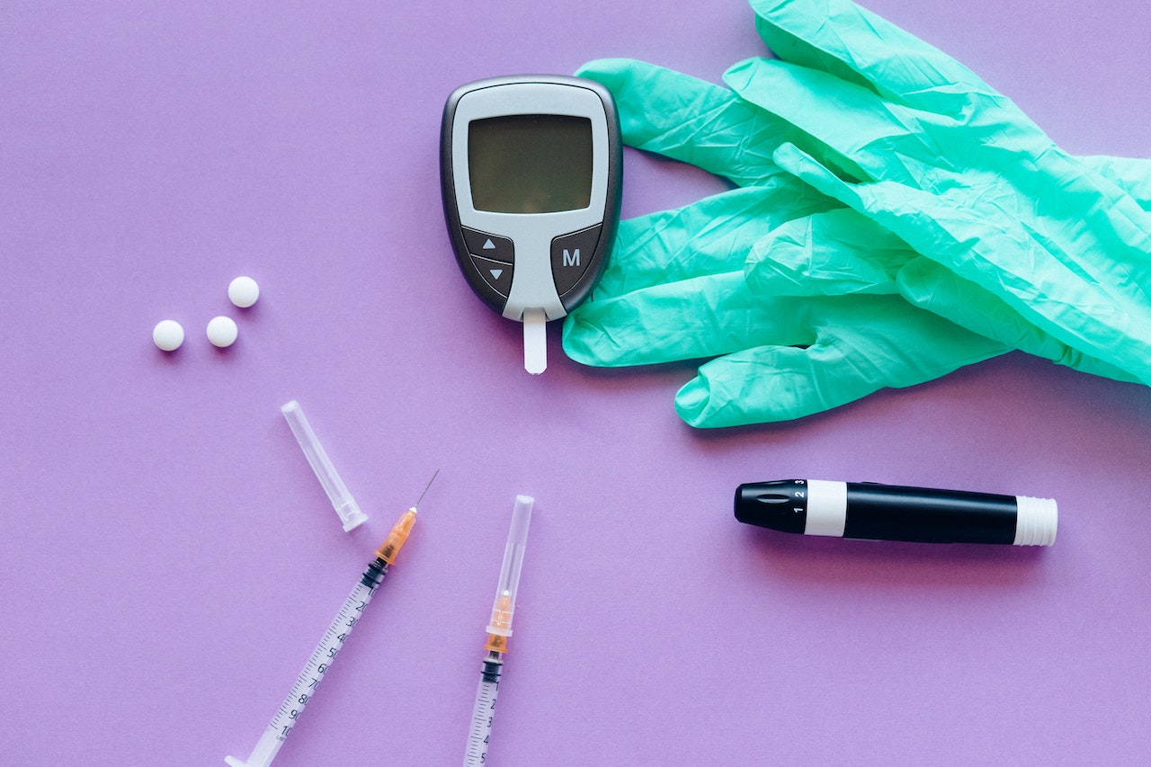 An image of medical testing equipments such as glucose meters, gloves.