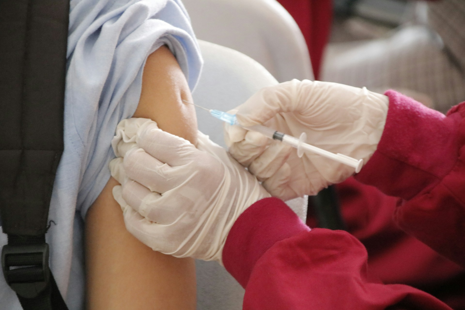 A medical professional administering vaccine. 