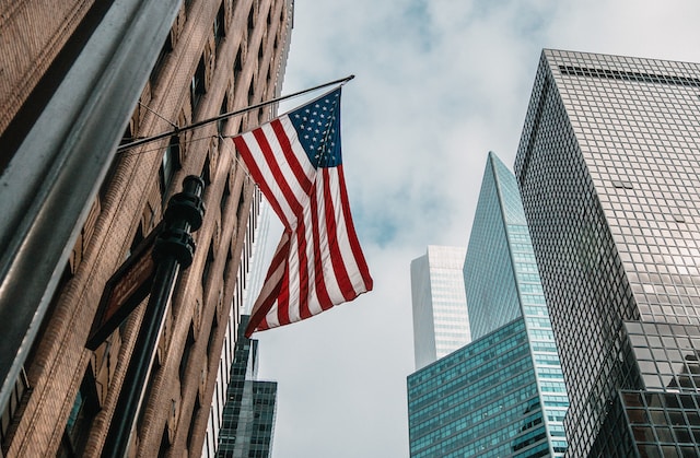 US flag on high-rise city building.