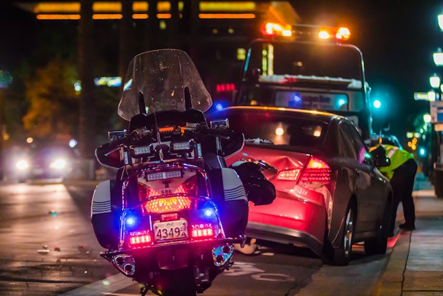 A police motorbike parked near a vehicle that met with an accident. 